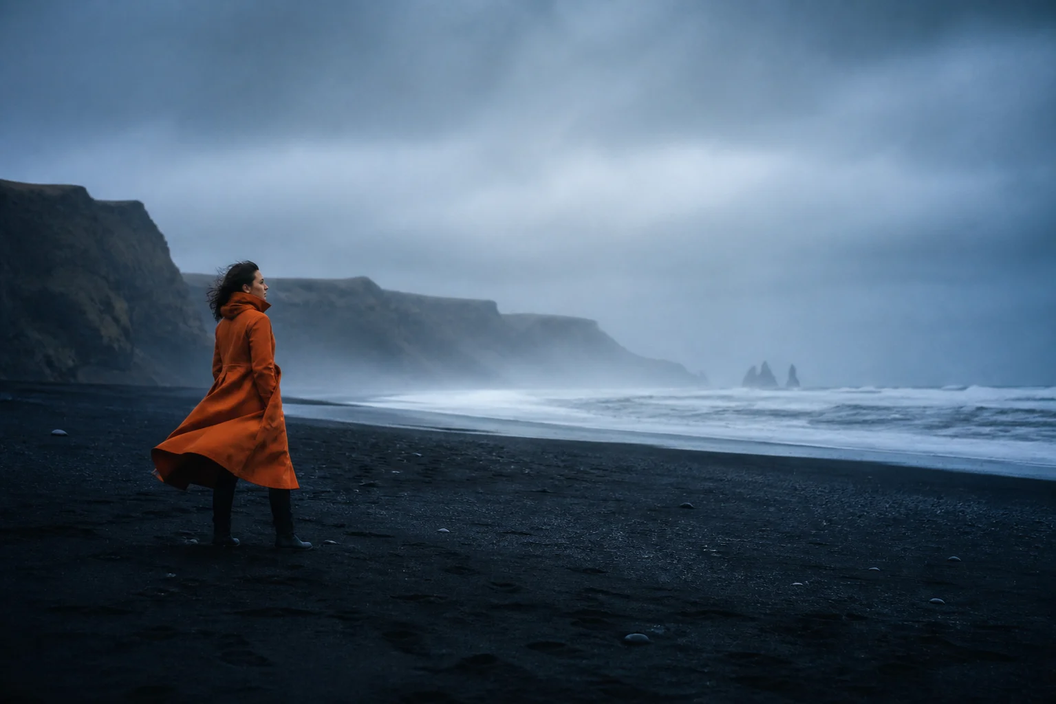 Generated concept image: an orange coat against a large blue-grey coastal landscape